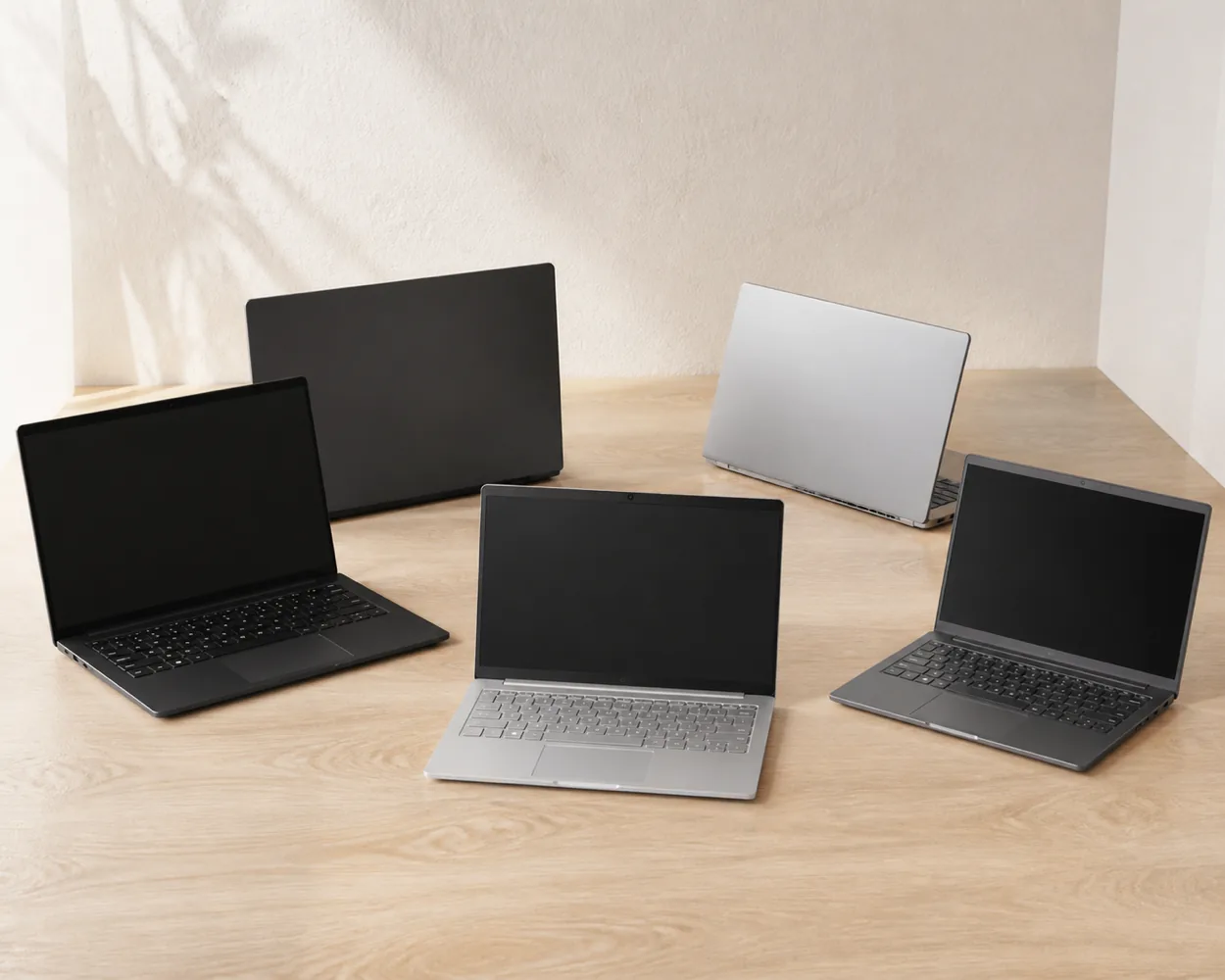 Selection of business laptops arranged on a wooden table